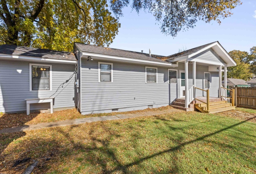 Back of house featuring crawl space and roof with shingles