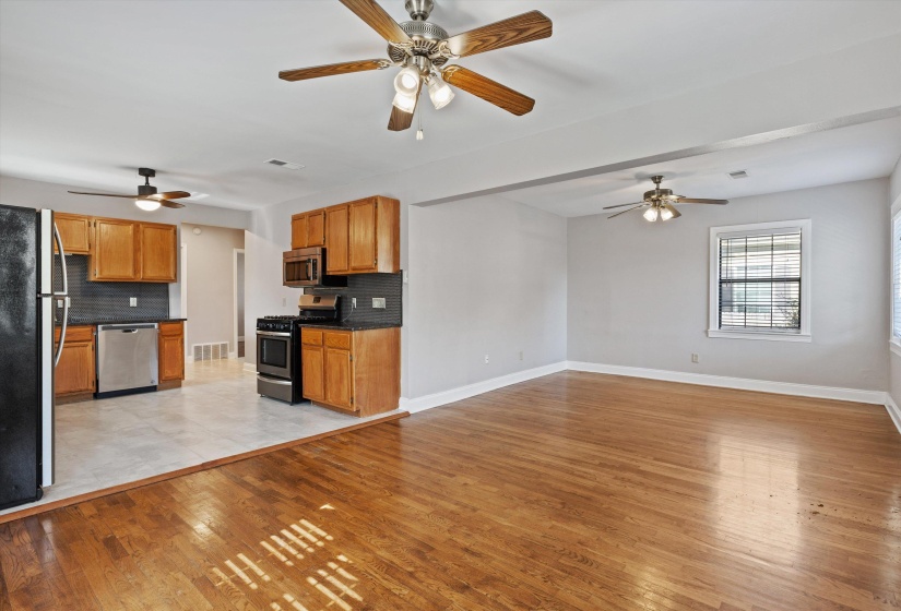 Kitchen with ceiling fan, brown cabinets, and light wood finished floors