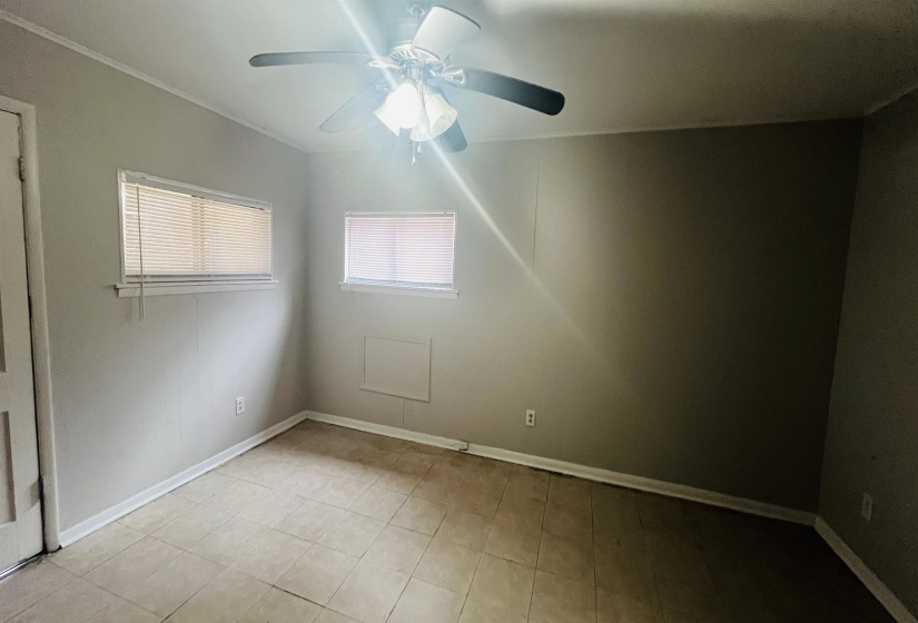 Empty room featuring baseboards and a ceiling fan