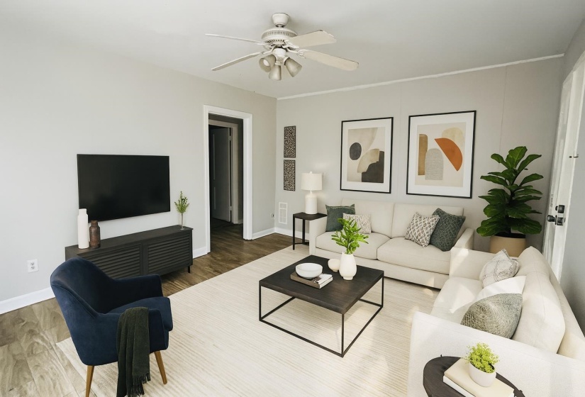 Living area with wood finished floors and ceiling fan