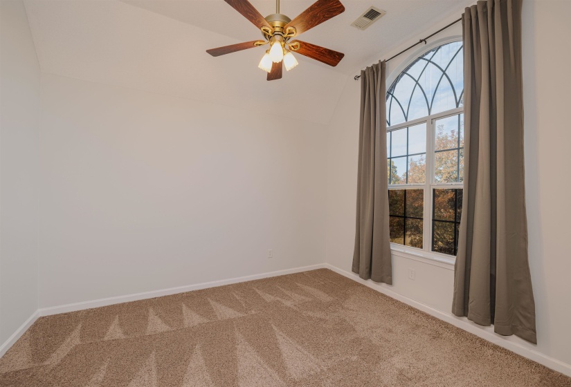 Bedroom featuring lofted ceiling, carpet, and ceiling fan