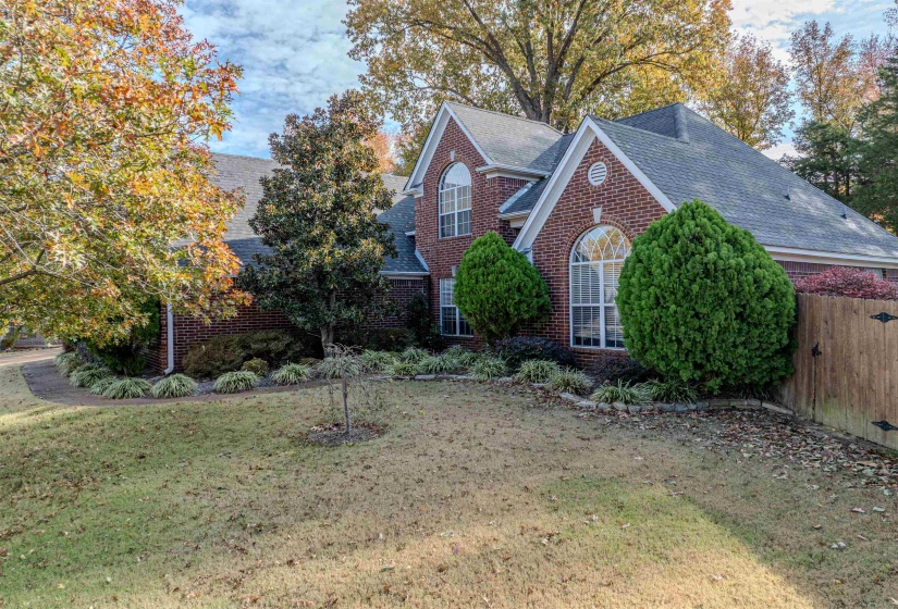 View of front of property featuring brick siding and roof with shingles