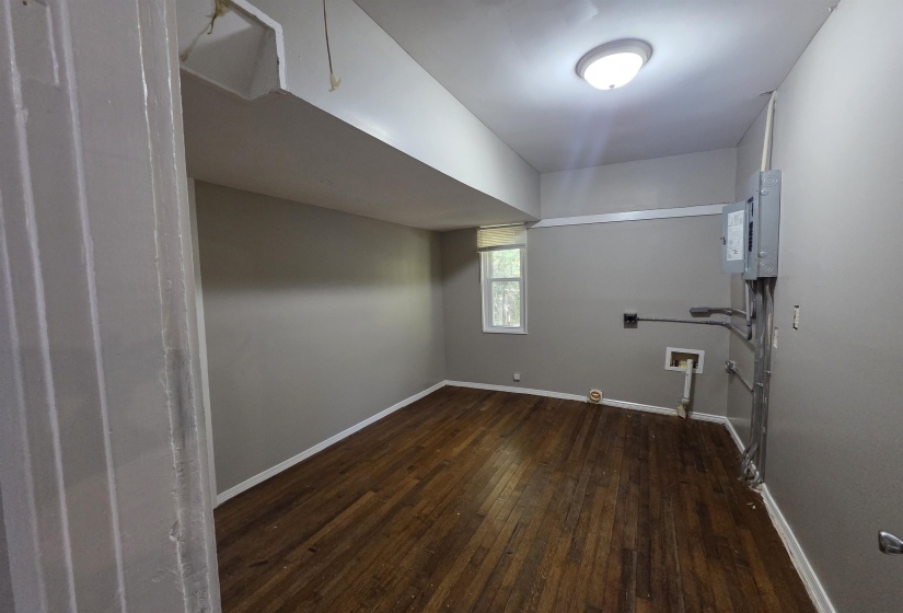 Laundry area featuring gas dryer hookup, dark wood-style floors, washer hookup, and electric dryer hookup