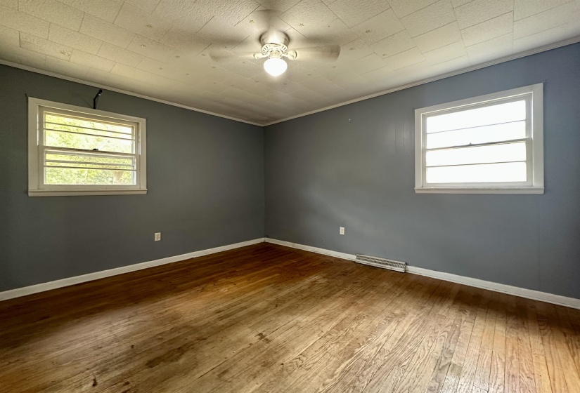Unfurnished room featuring wood-type flooring and ornamental molding