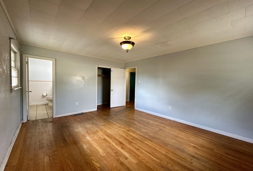 Unfurnished bedroom featuring hardwood / wood-style flooring and a closet