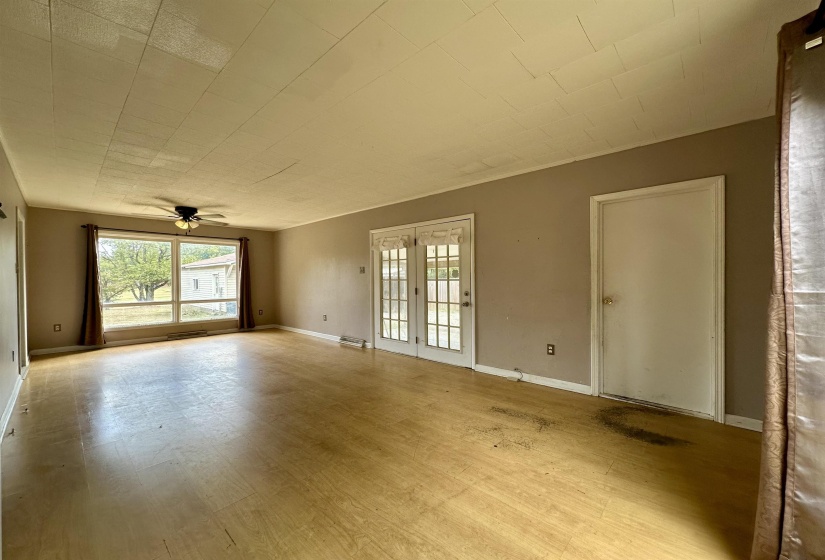Empty room featuring light wood finished floors and ceiling fan