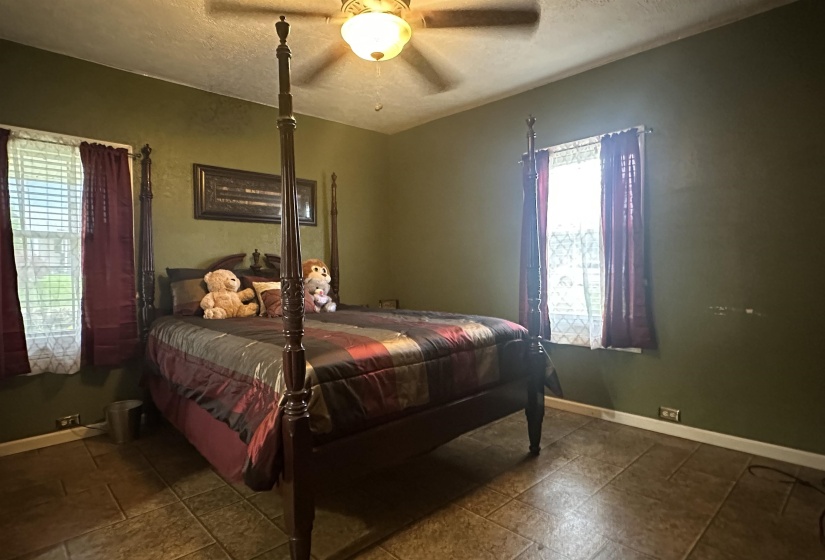 Bedroom with a textured ceiling and ceiling fan