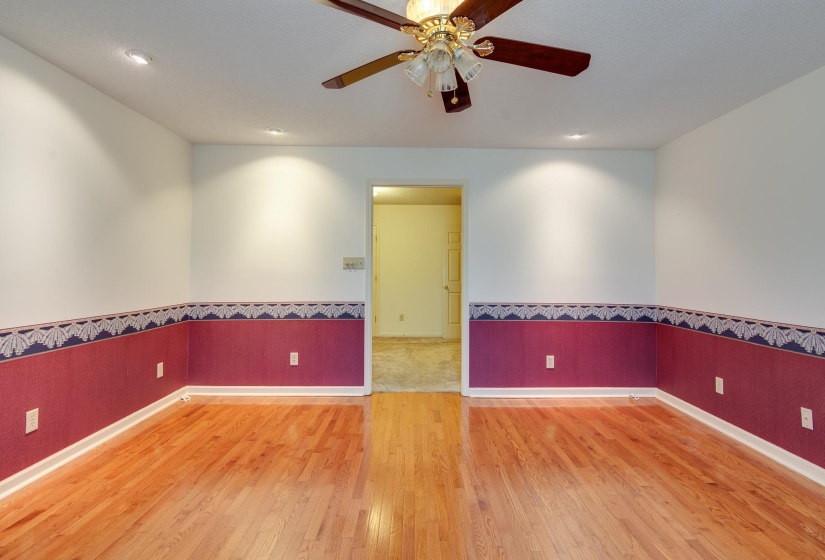 Spare room featuring a wainscoted wall, wood finished floors, a ceiling fan, and recessed lighting