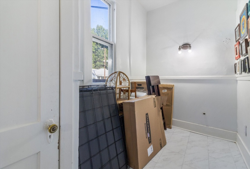 Bathroom featuring marble look tile flooring and baseboards