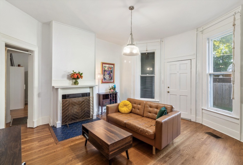 Living area featuring wood finished floors and a fireplace with flush hearth