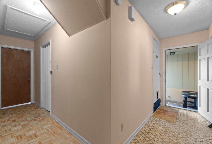 Corridor featuring a textured ceiling and baseboards