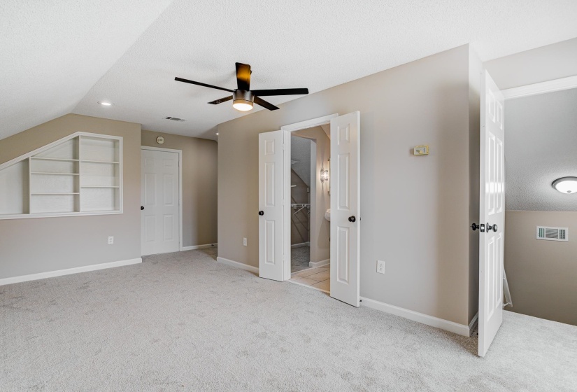 Unfurnished bedroom with carpet floors, a ceiling fan, and baseboards