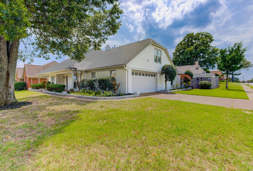 View of front of property with asphalt driveway, brick siding, and roof with shingles