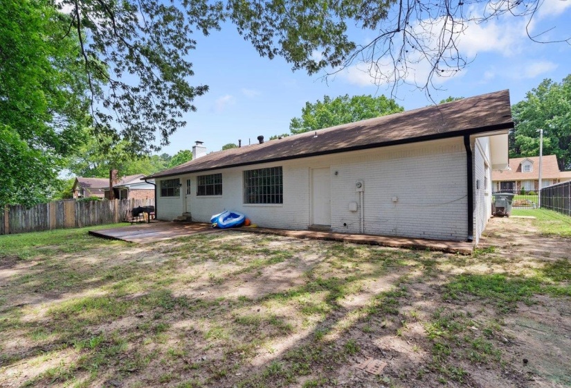 Rear view of property featuring brick siding and a patio