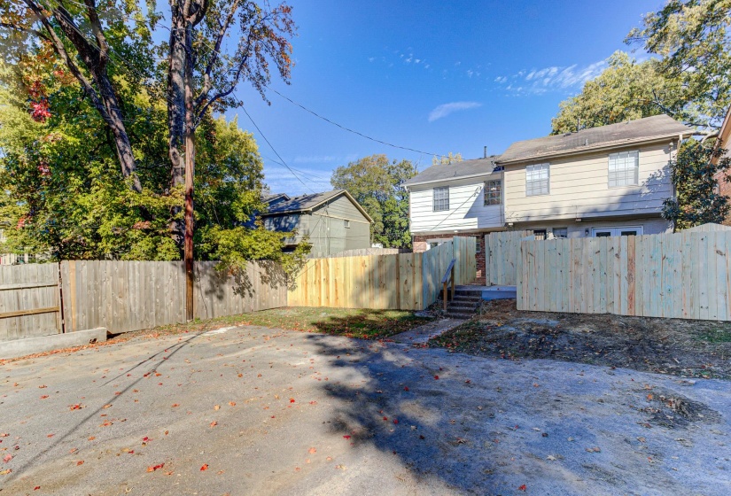 Back of house with a fenced backyard