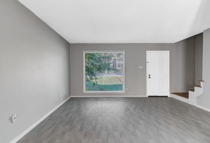 Empty room with wood finished floors and stairs