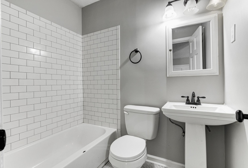 Full bath featuring shower / tub combination and toilet
