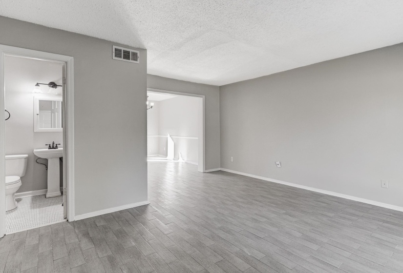 Spare room with a textured ceiling, light wood finished floors, and a chandelier