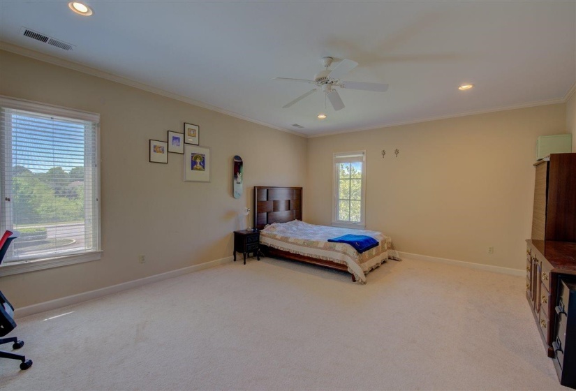 Bedroom with recessed lighting, light colored carpet, crown molding, and a ceiling fan