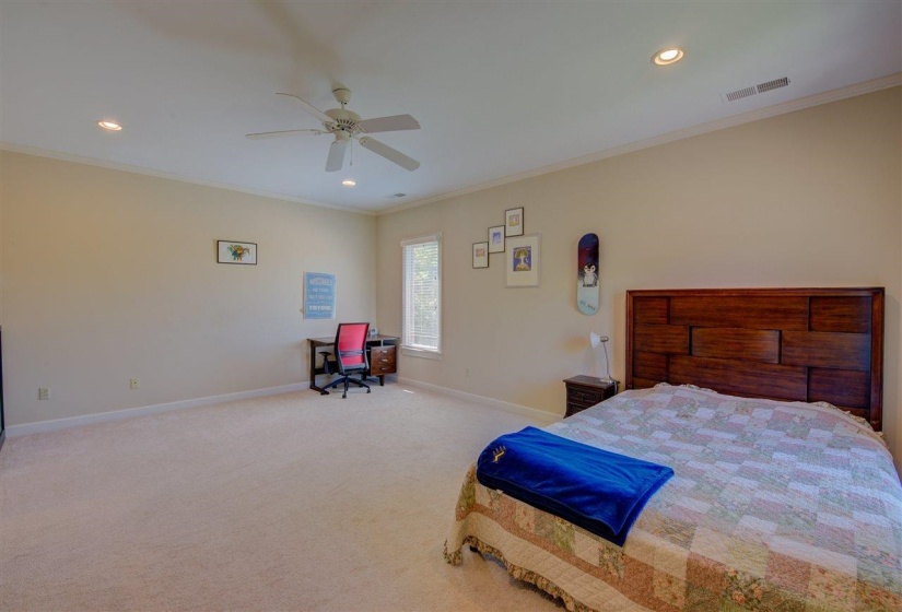 Carpeted bedroom featuring recessed lighting, crown molding, ceiling fan, and an office area