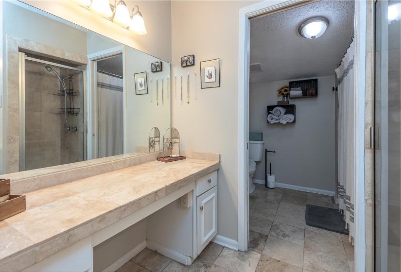 This adjoins the Primary and has great counter space. There is a tub and a shower. There is a door to left of commode that opens to hallway for sharing with 2nd bedroom.