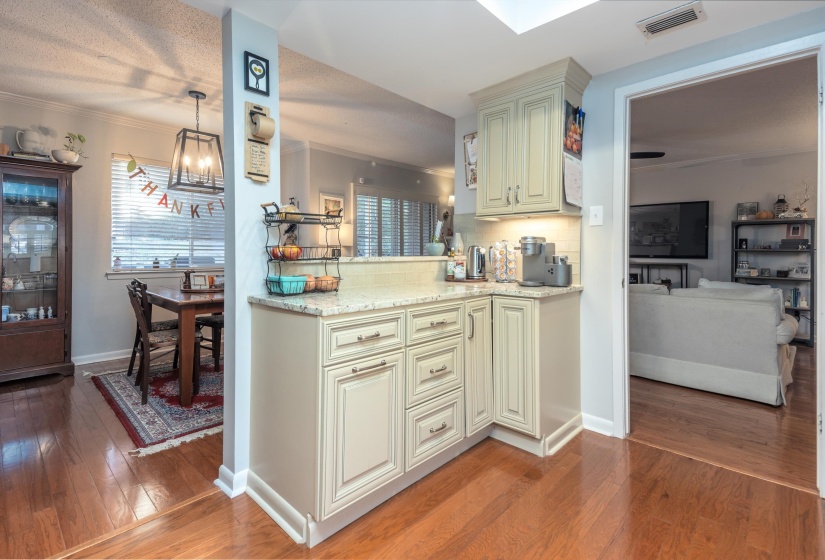 Nice storage in this part of the kitchen and a pass through to the dining room and a breakfast bar on the other side.