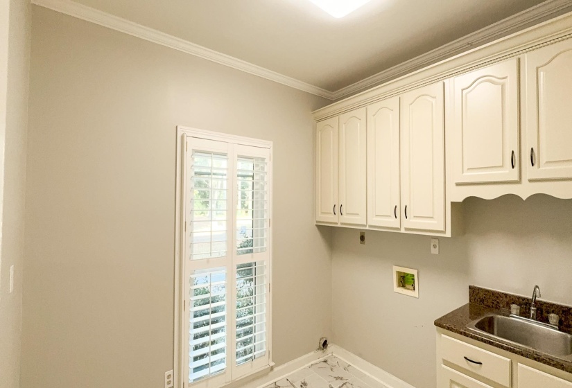 Laundry room with ornamental molding, cabinet space, washer hookup, and hookup for an electric dryer