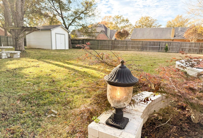 Fenced backyard with a storage shed
