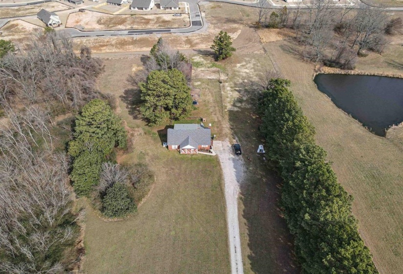 Aerial view of property and surrounding area featuring a large body of water