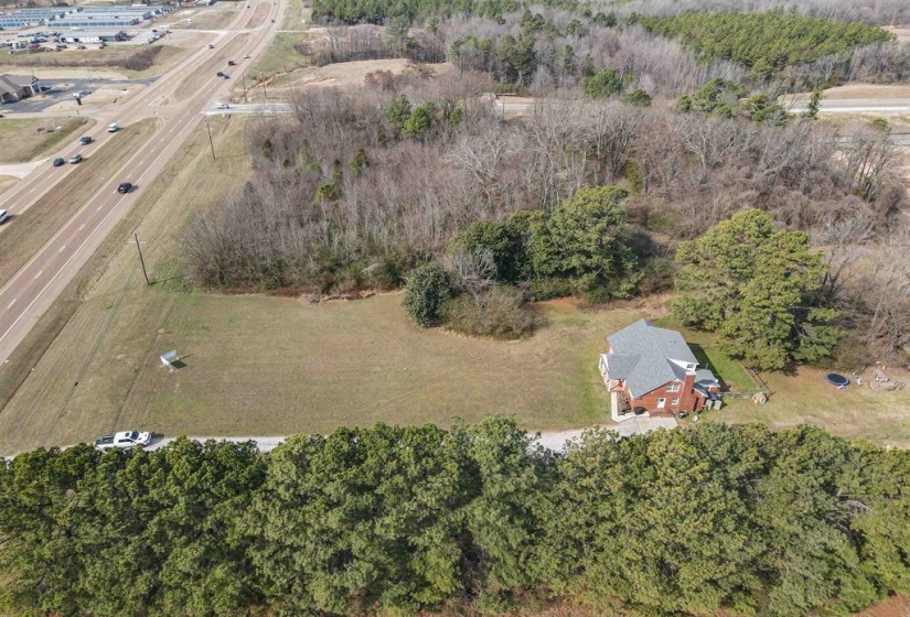 View of property location with a tree filled landscape