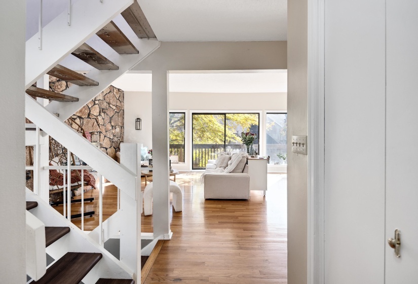 Stairs featuring wood finished floors