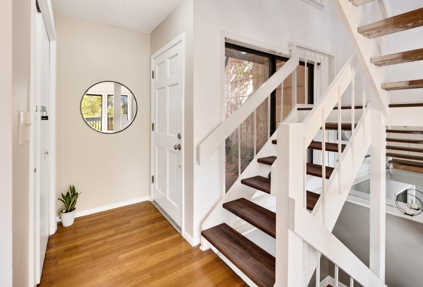 Staircase featuring wood finished floors and baseboards