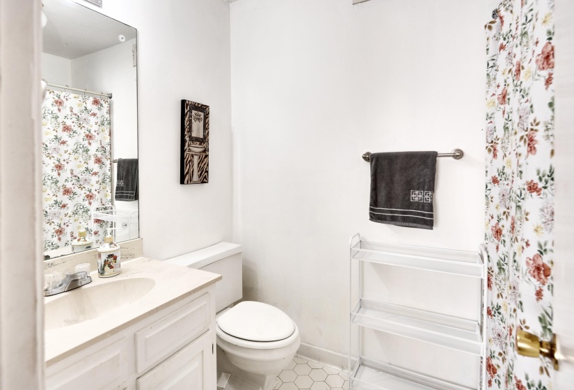 Bathroom featuring vanity, a shower with shower curtain, and light tile patterned floors