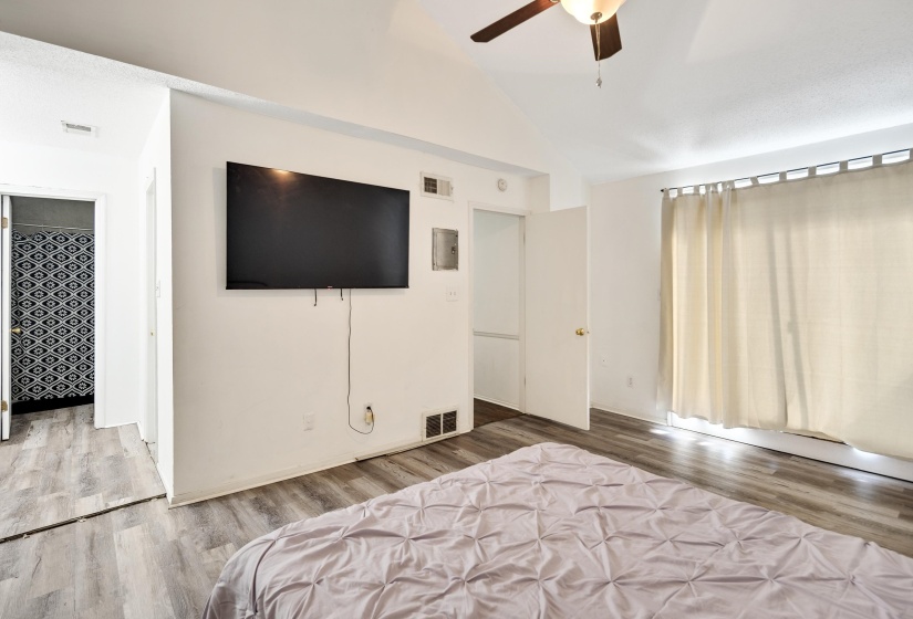 Bedroom featuring vaulted ceiling, ceiling fan, and wood finished floors