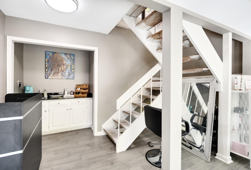 Stairs featuring wood finished floors and baseboards