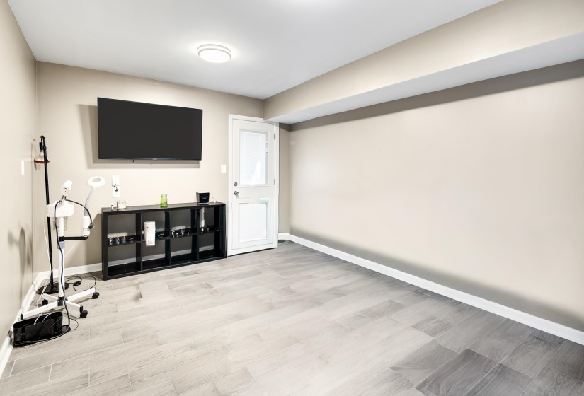 Unfurnished living room with light wood finished floors and baseboards