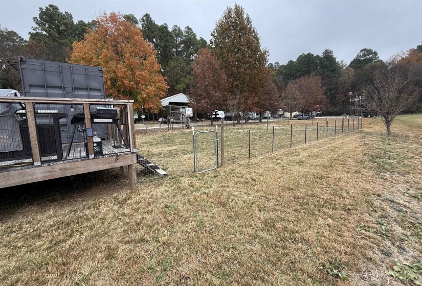 View of yard with a deck and view of scattered trees