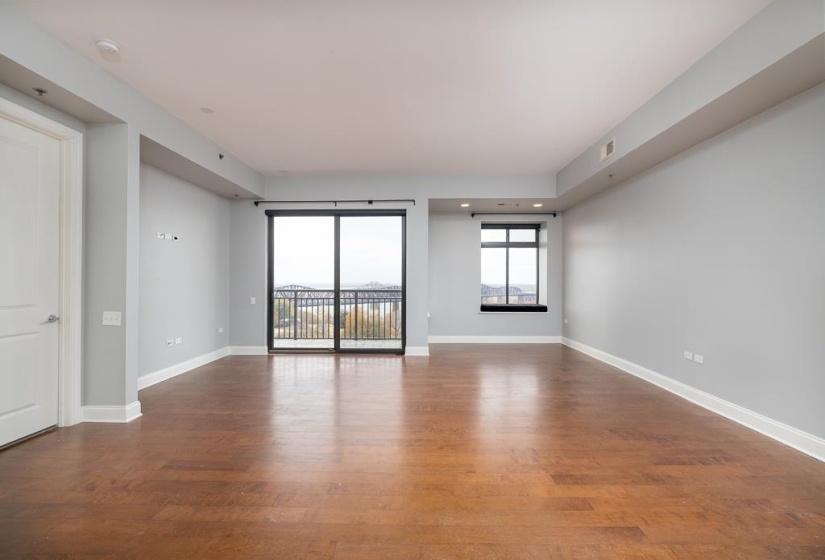Unfurnished room with dark wood-type flooring