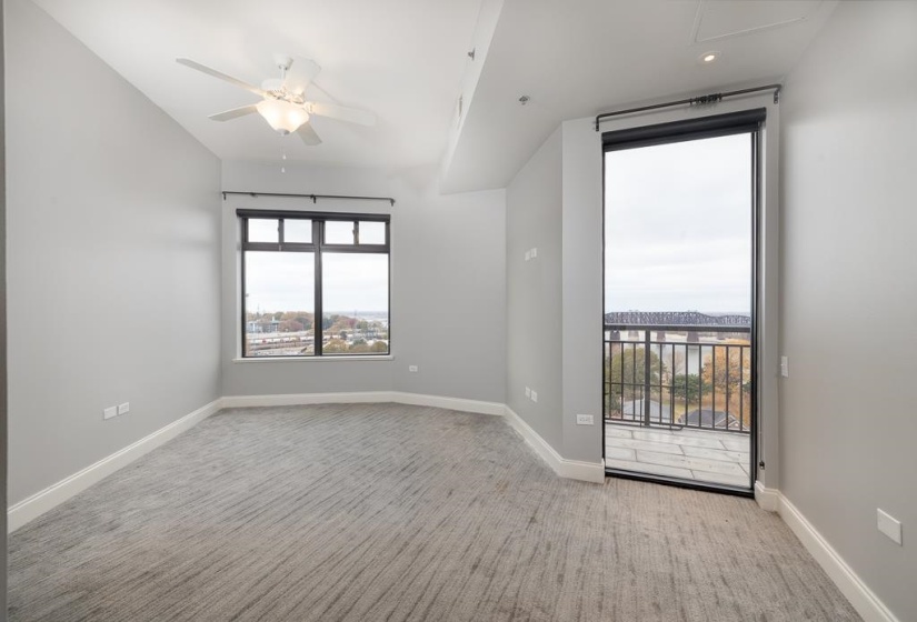 Unfurnished room featuring light colored carpet and a ceiling fan