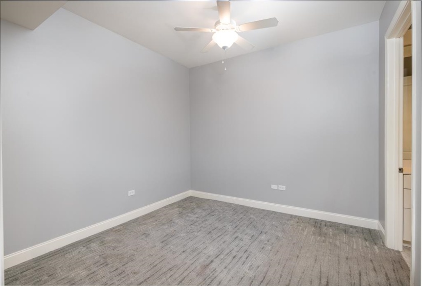Spare room featuring a ceiling fan and light wood-style flooring