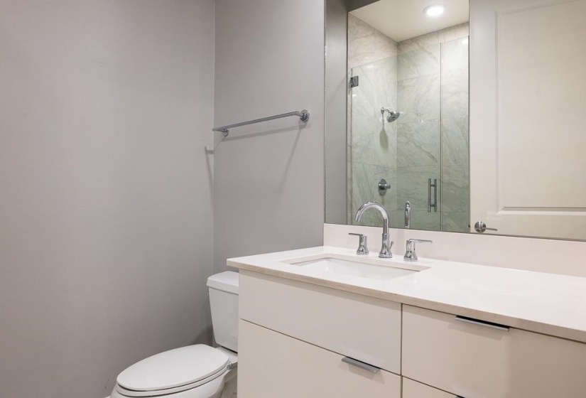 Full bath with vanity and a shower stall