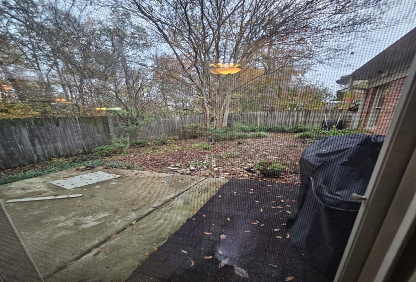 Fenced backyard with a patio area