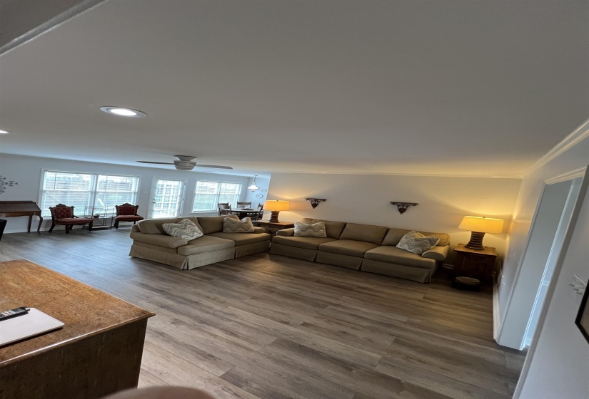 Living area featuring wood finished floors, ceiling fan, and recessed lighting
