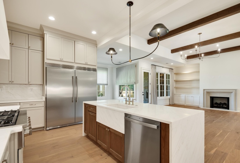 Kitchen with appliances with stainless steel finishes, a sink, recessed lighting, light wood-type flooring, and hanging light fixtures
