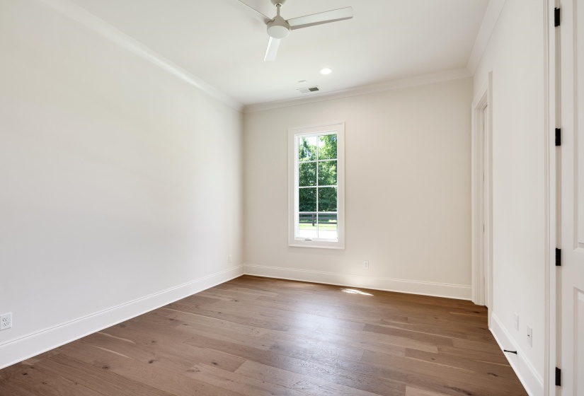 Empty room featuring ornamental molding, baseboards, wood finished floors, ceiling fan, and recessed lighting