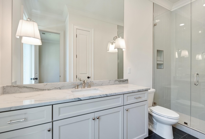 Full bathroom with ornamental molding, vanity, a shower stall, and toilet