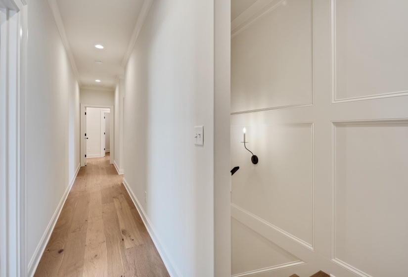 Hall featuring crown molding, light wood-style flooring, recessed lighting, and baseboards