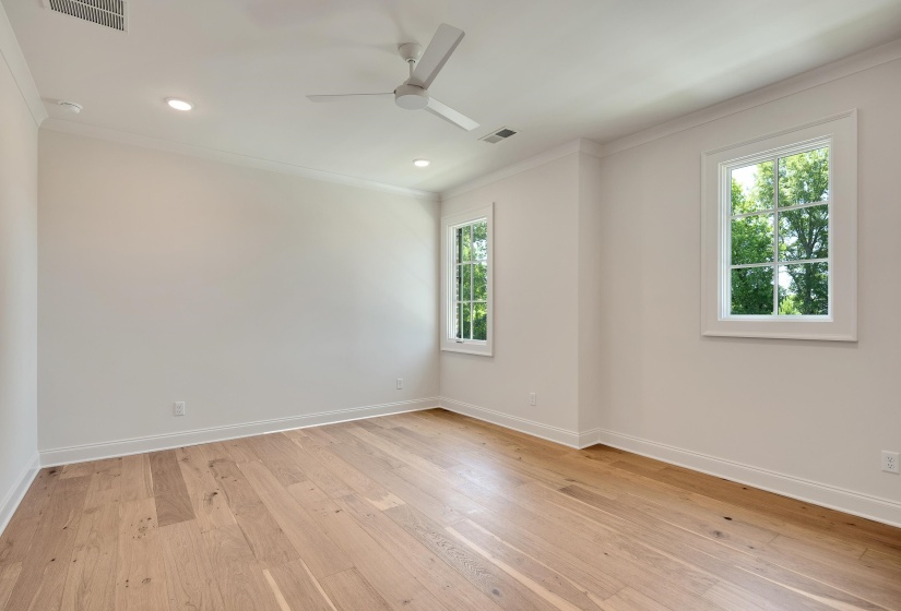 Unfurnished room featuring crown molding, baseboards, light wood-style floors, and recessed lighting
