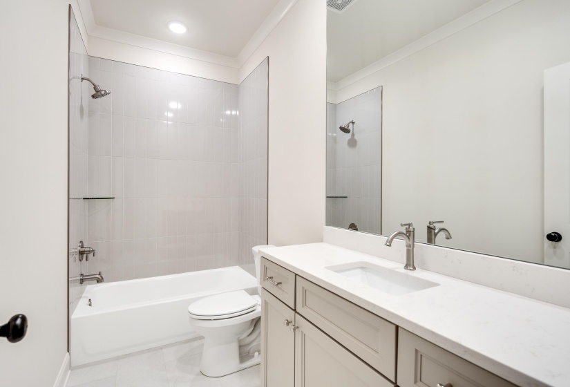 Full bath with vanity, toilet, ornamental molding, washtub / shower combination, and tile patterned flooring
