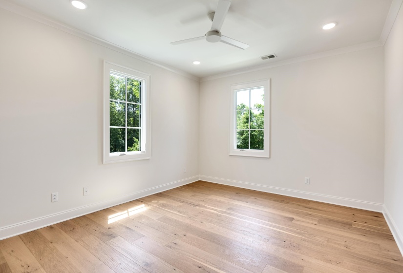 Spare room with healthy amount of natural light, crown molding, a ceiling fan, light wood finished floors, and recessed lighting